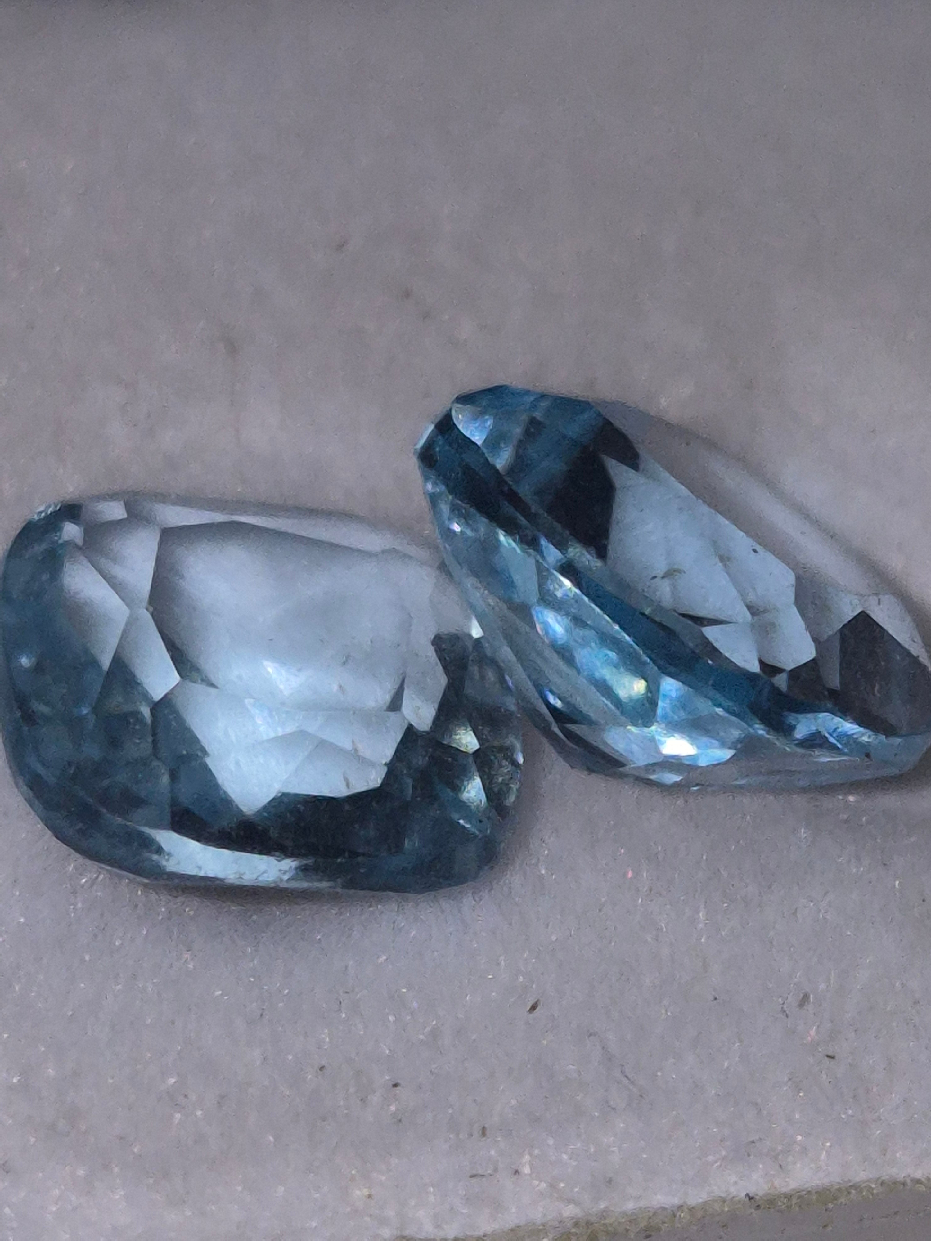 Blue topaz matched pair showing brilliant sky blue color and square princess cut faceting for custom jewelry design