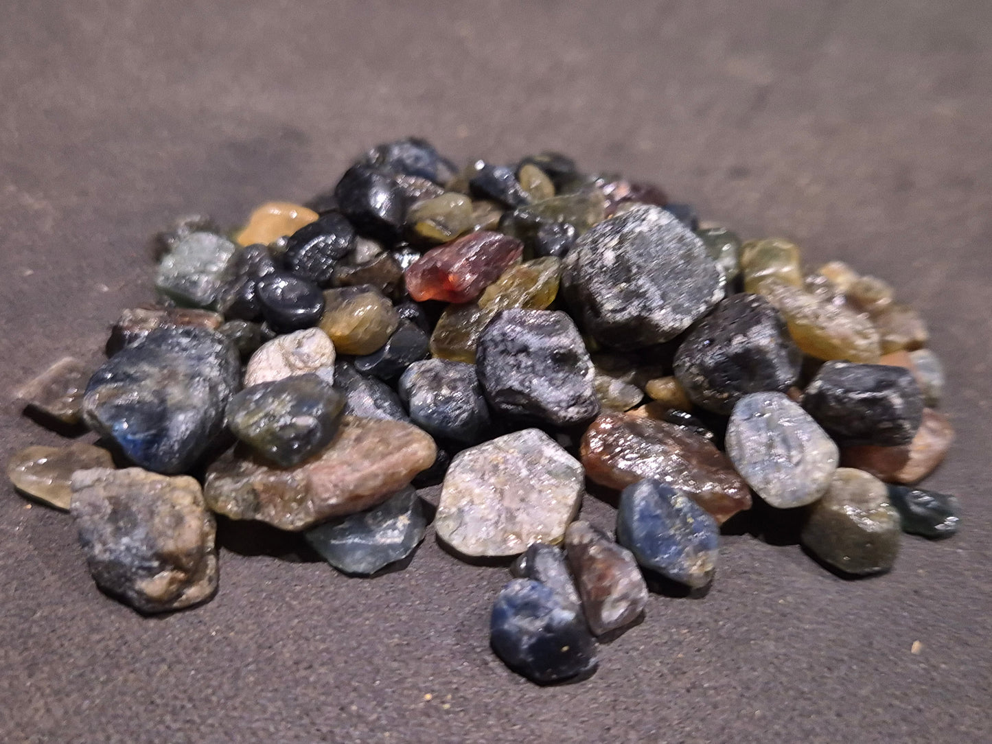 Queensland sapphire rough parcel from Sapphire QLD Australia showing natural uncut corundum crystals from Central Queensland Gemfields
