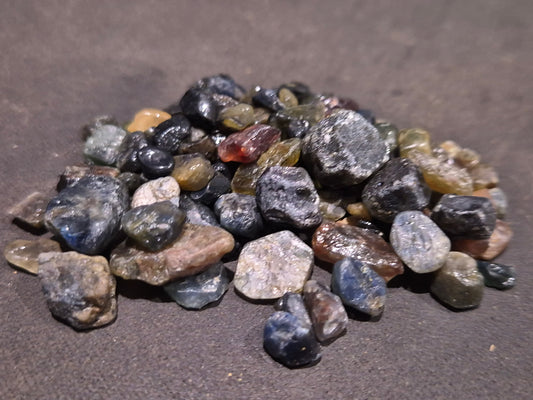 Queensland sapphire rough parcel from Sapphire QLD Australia showing natural uncut corundum crystals from Central Queensland Gemfields
